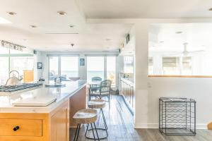 a kitchen with white walls and a counter with stools at 2nd Base in Sawyer