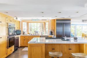 a kitchen with wooden cabinets and a stainless steel refrigerator at 2nd Base in Sawyer +23 photos
