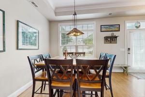 a dining room with a table and chairs at Beacon Court Condo F in Douglas +17 photos