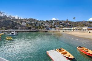 two boats in the water next to a beach at 221CL 221 Claressa Ave in Avalon