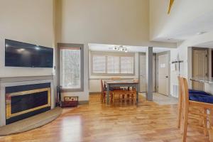 a living room with a table and a fireplace at WinterGreen Condo, #522 in Thompsonville