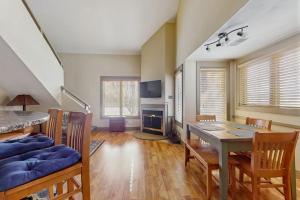 a living room with a dining room table and chairs at WinterGreen Condo, #522 in Thompsonville