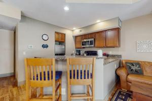 a kitchen with two chairs and a counter top at WinterGreen Condo, #522 in Thompsonville