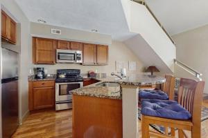 a kitchen with a sink and a stove top oven at WinterGreen Condo, #522 in Thompsonville