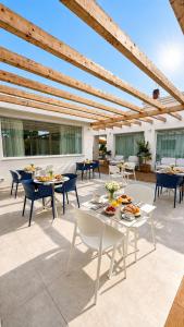 a patio with tables and chairs on a patio at Novaeos Sicily in Terrasini