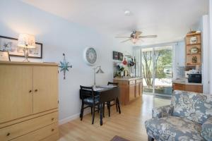 a living room with a couch and a table with a desk at Waterside Suites in Saugatuck