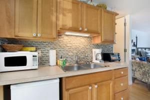 a kitchen with a sink and a microwave at Waterside Suites in Saugatuck +12 photos