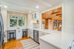 a kitchen with white countertops and a wooden ceiling at Birchwood: Meadows Bliss in Harbor Springs