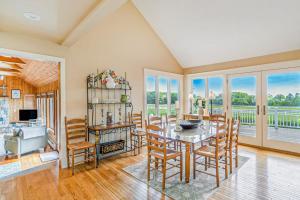 a dining room with a table and chairs at Birchwood: Meadows Bliss in Harbor Springs