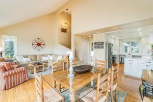 a living room with a table and a kitchen at Birchwood: Meadows Bliss in Harbor Springs +32 photos