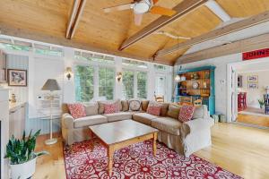 a living room with a couch and a table at Happy Thoughts Cottage in New Buffalo