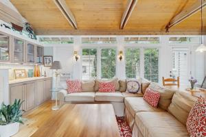 a living room with a couch and a table at Happy Thoughts Cottage in New Buffalo