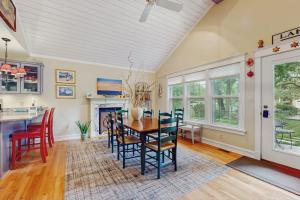 a kitchen and dining room with a table and chairs at Happy Thoughts Cottage in New Buffalo