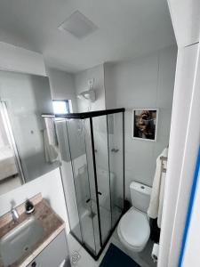 a bathroom with a shower and a toilet and a sink at Laguna beach house in Cabedelo