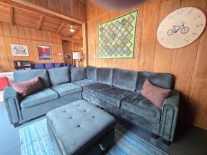 a living room with a couch and a clock on the wall at Petoskey Stone Lodge in Bellaire