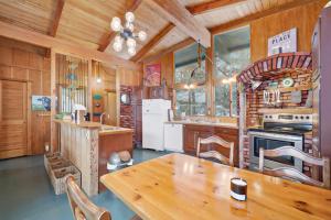a wooden kitchen with a wooden table in a cabin at Petoskey Stone Lodge in Bellaire