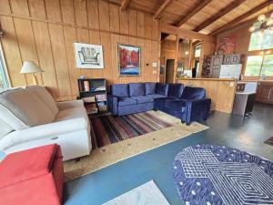 a living room with a blue couch and a table at Petoskey Stone Lodge in Bellaire