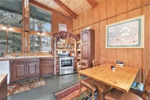 a kitchen with wooden walls and a wooden table at Petoskey Stone Lodge in Bellaire