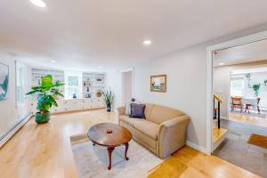 a living room with a couch and a table at Private Pocasset Getaway in Pocasset