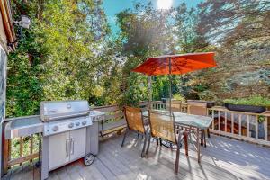 a patio with a table and a grill and an umbrella at Private Pocasset Getaway in Pocasset