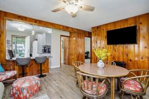 a living room with a table and a tv at Lake Michigan Charmer in Union Pier