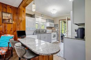 a kitchen with a table with chairs and a laptop at Lake Michigan Charmer in Union Pier +27 photos
