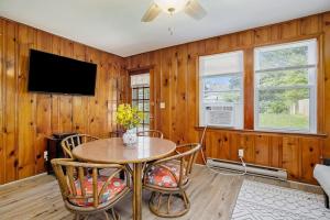 a dining room with a table and chairs and a tv at Lake Michigan Charmer in Union Pier
