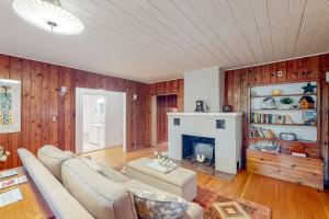 a living room with a couch and a fireplace at Wanderlust in Glen Arbor