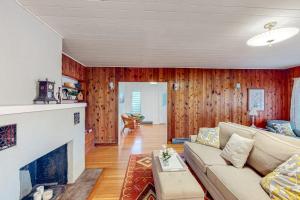 a living room with a couch and a fireplace at Wanderlust in Glen Arbor