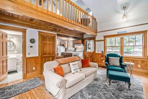 a living room with a white couch and a blue chair at Cedar Nook in Arcadia