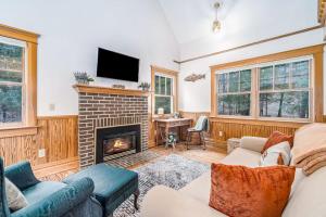 a living room with a couch and a fireplace at Cedar Nook in Arcadia