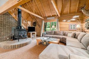 a living room with a couch and a fireplace at The Log Cabin in Thompsonville