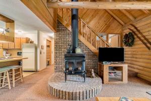 a living room with a woodburning stove in a house at The Log Cabin in Thompsonville