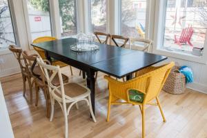 a dining room with a black table and chairs at Sunshine Villa in Union Pier