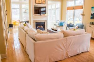 a living room with a white couch and a fireplace at Sunshine Villa in Union Pier