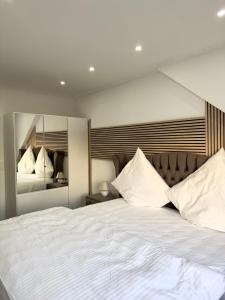 a bedroom with a large bed with white sheets and pillows at MIO plus Apartments Sulzbach in Sulzbach
