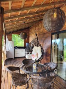 a patio with a table and chairs on a deck at Cantinho do marinheiro in Paraty