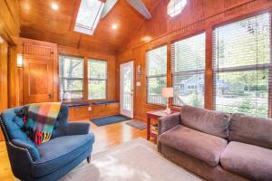 a living room with a couch and a chair at Coast Away in Union Pier