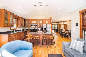 a large kitchen with a blue couch and a blue chair at Coast Away in Union Pier +31 photos