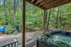 a screened in porch with a tub in the woods at The Oasis at Forest Beach in New Buffalo