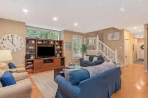 a living room with blue couches and a large clock at The Oasis at Forest Beach in New Buffalo