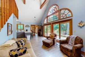 a large living room with a couch and chairs at Creeping Snails in Glen Arbor