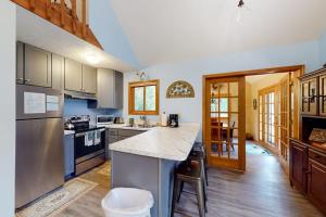a kitchen with a large island in the middle at Creeping Snails in Glen Arbor