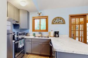 a kitchen with a sink and a counter top at Creeping Snails in Glen Arbor
