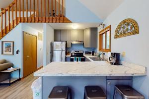 a kitchen with a large counter top in a room at Creeping Snails in Glen Arbor
