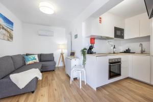 a living room with a couch and a kitchen at SagresSeaHouse in Sagres +19 photos