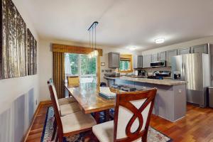 a kitchen with a dining table and a refrigerator at Red Arrow Lodge in Sawyer