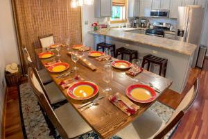 a wooden table with plates and glasses on it in a kitchen at Red Arrow Lodge in Sawyer +21 photos