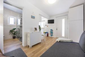 a living room with white walls and wooden floors at SagresSeaHouse in Sagres
