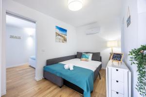 a small bedroom with a bed and a table at SagresSeaHouse in Sagres